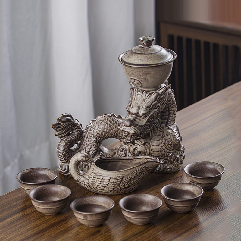 Automatic glass tea set with rotating base and embossed dragon design