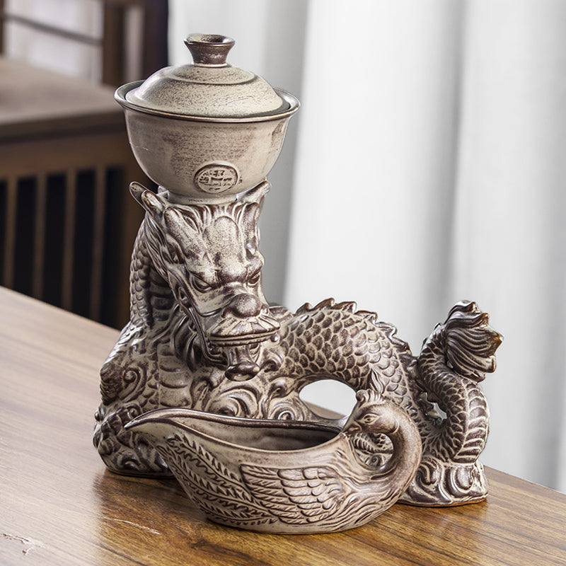 Dragon relief detail on glass automatic tea set base